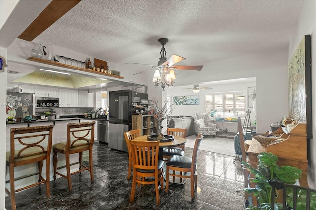 dining room with a textured ceiling and ceiling fan