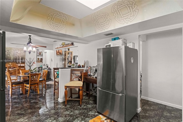 kitchen with ceiling fan and stainless steel refrigerator