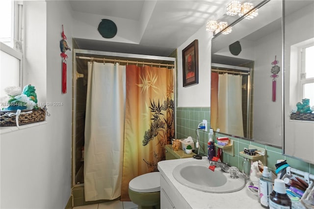 bathroom with tile walls, vanity, curtained shower, and toilet