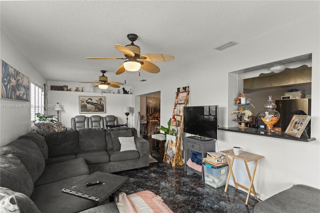 living room featuring ceiling fan and a textured ceiling