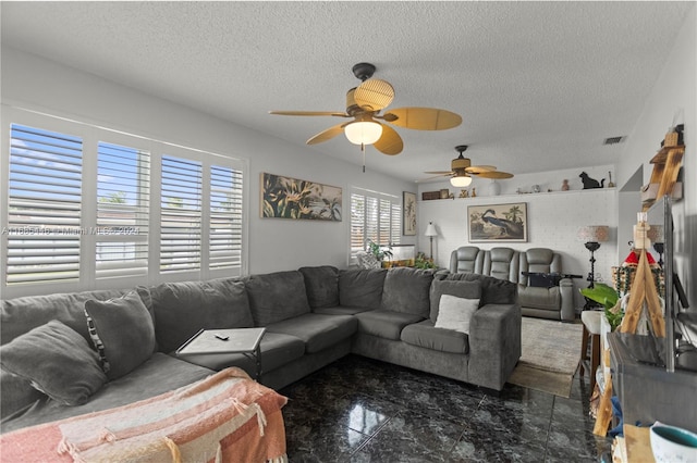 living room featuring a textured ceiling and ceiling fan