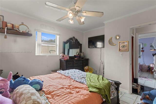 bedroom featuring ceiling fan, crown molding, and light tile patterned flooring