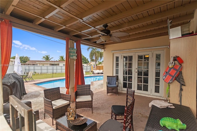 view of patio featuring french doors, ceiling fan, and a fenced in pool