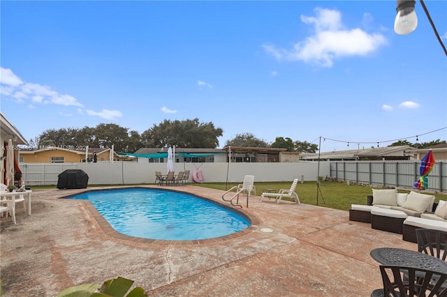 view of pool with a patio, grilling area, a lawn, and an outdoor hangout area