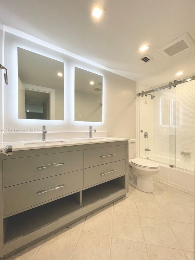 full bathroom featuring vanity, bath / shower combo with glass door, toilet, and tile patterned floors