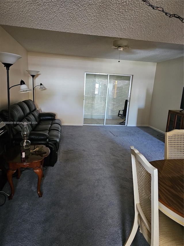 living room with a textured ceiling and carpet flooring