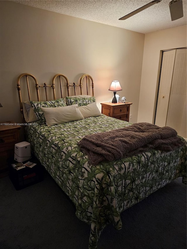 carpeted bedroom with a closet, a textured ceiling, and ceiling fan