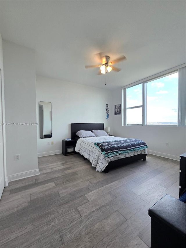 bedroom featuring hardwood / wood-style floors and ceiling fan