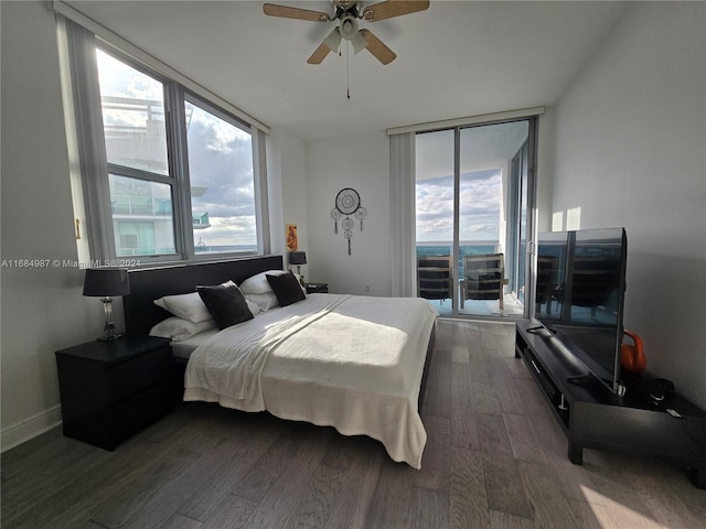 bedroom with dark hardwood / wood-style flooring, ceiling fan, and access to exterior