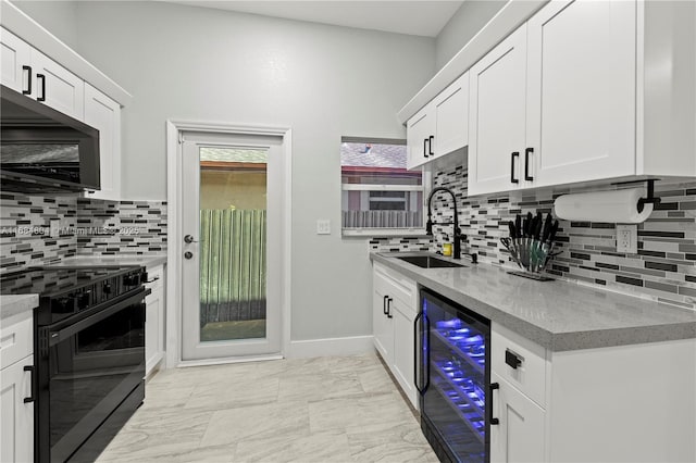 kitchen featuring wine cooler, white cabinetry, black range with electric stovetop, and a sink