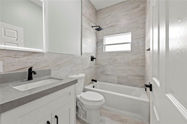 bathroom with tile walls, bathtub / shower combination, backsplash, toilet, and vanity