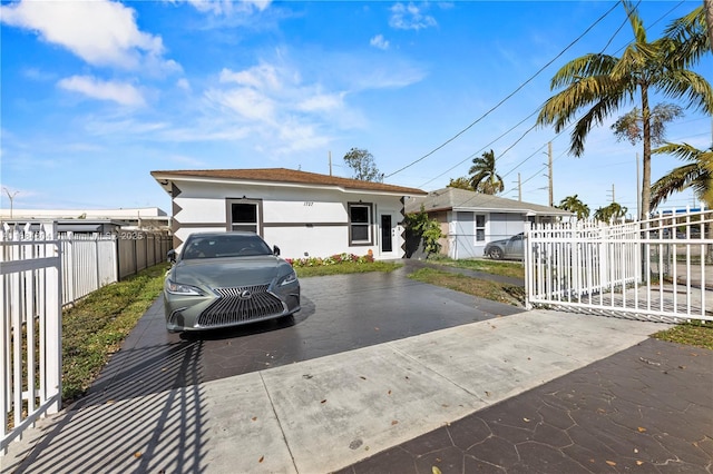 ranch-style home featuring fence private yard, driveway, and stucco siding