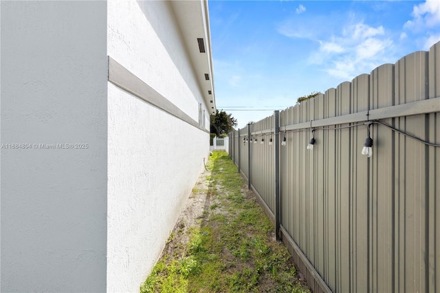 exterior space featuring fence and stucco siding