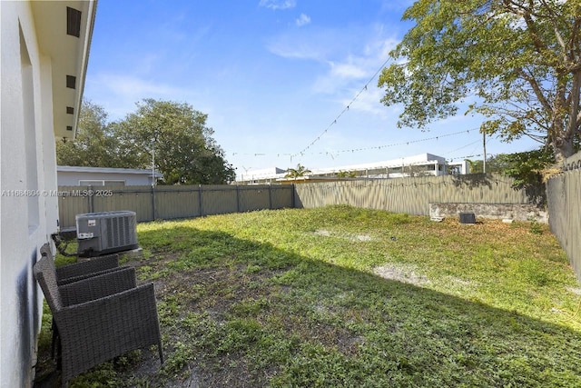 view of yard featuring a fenced backyard and central AC