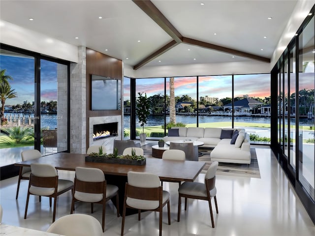 dining space with a water view and a fireplace