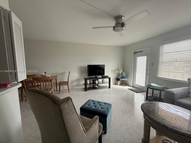 living room featuring light tile patterned flooring and ceiling fan