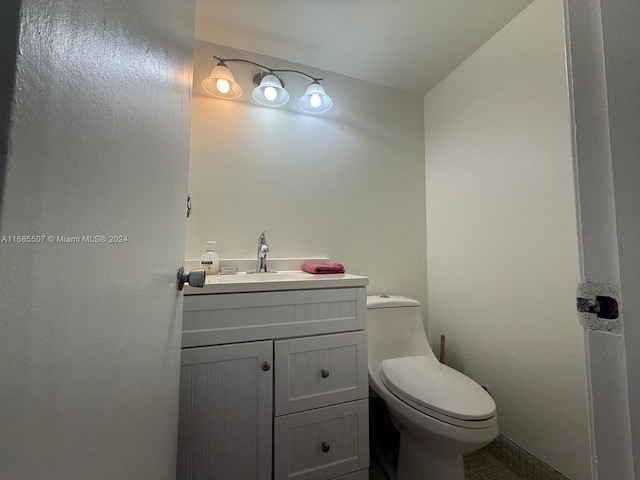 bathroom with toilet and vanity