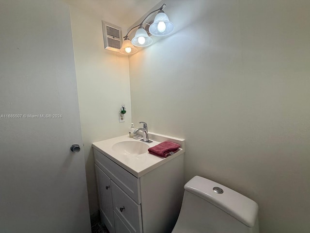 bathroom with toilet and vanity