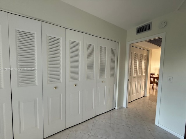 unfurnished bedroom featuring light tile patterned flooring