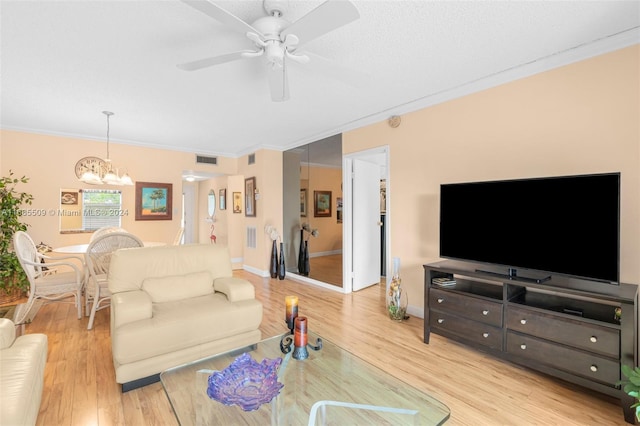 living room with crown molding, light hardwood / wood-style flooring, and ceiling fan with notable chandelier