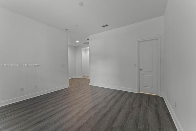 empty room with dark hardwood / wood-style floors