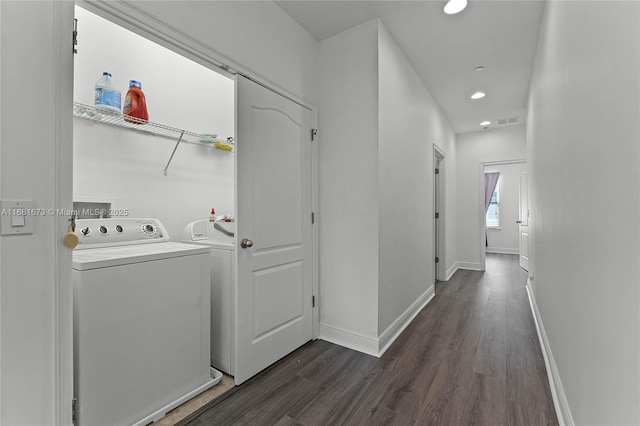 washroom with washer / dryer and dark wood-type flooring