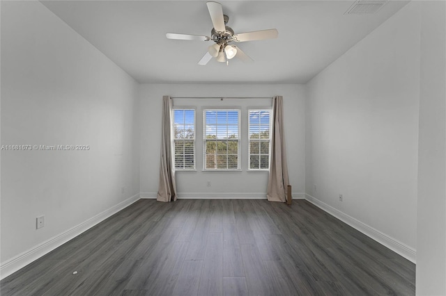 empty room with dark wood-type flooring and ceiling fan