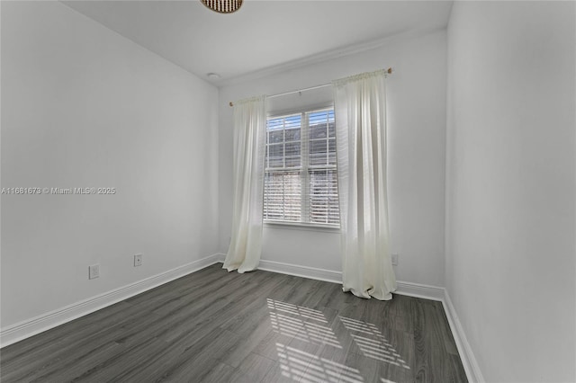 unfurnished room with dark hardwood / wood-style flooring