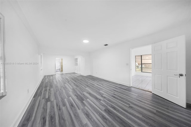 unfurnished room with dark hardwood / wood-style flooring