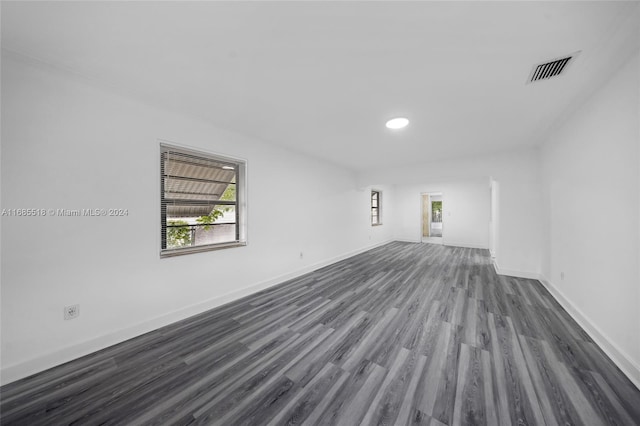 empty room with dark hardwood / wood-style flooring