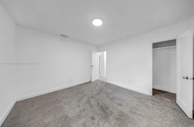 unfurnished bedroom featuring a closet and carpet