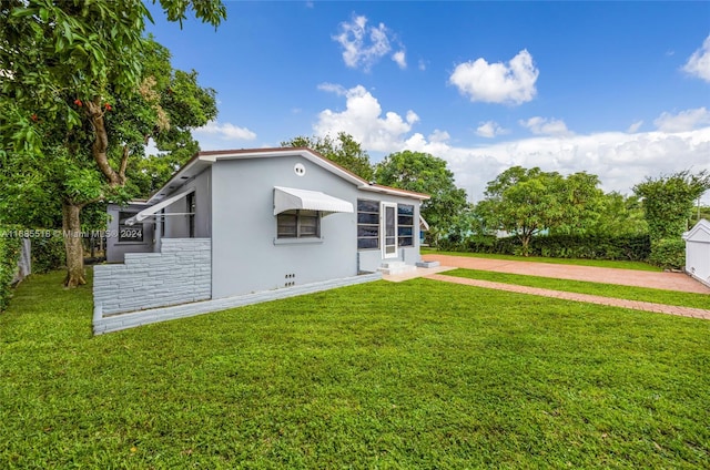 rear view of property with a lawn