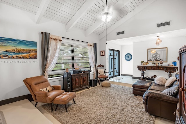 living room with beam ceiling and high vaulted ceiling