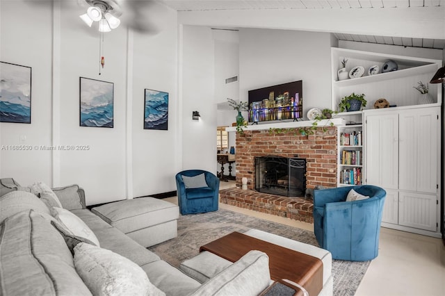 living room featuring vaulted ceiling with beams, wood ceiling, a brick fireplace, and ceiling fan