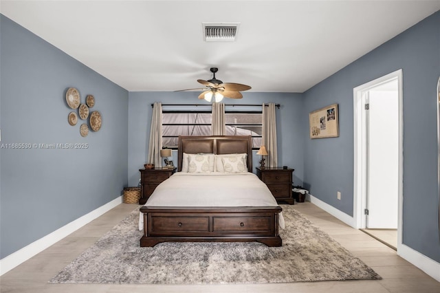 bedroom with light hardwood / wood-style floors and ceiling fan