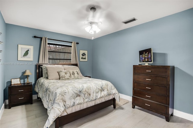 bedroom with ceiling fan and light hardwood / wood-style flooring