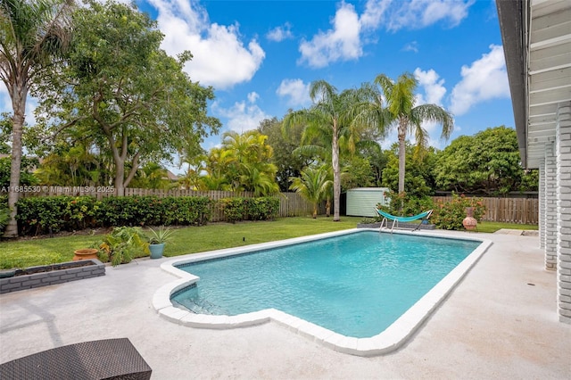 view of pool with a yard and a patio