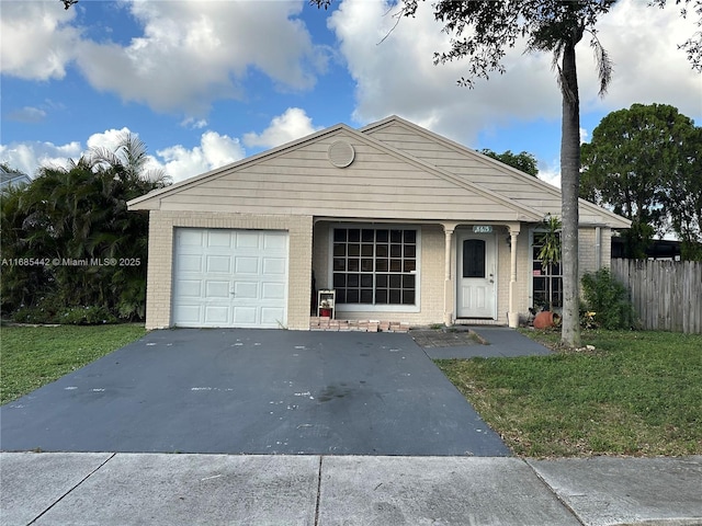 view of front of property with a garage and a front yard