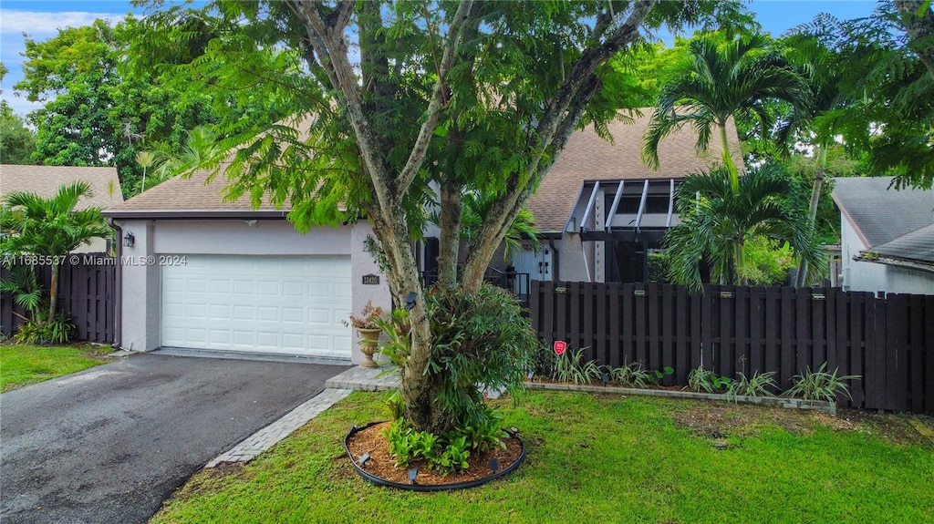 view of front of property with a front lawn and a garage