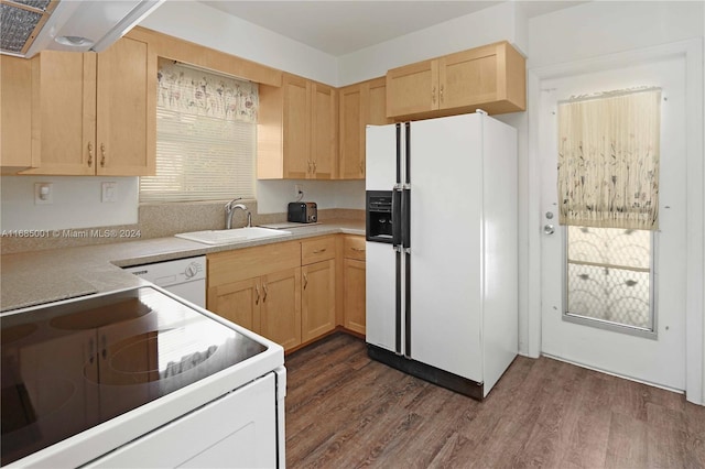 kitchen featuring white appliances, dark hardwood / wood-style flooring, light brown cabinets, and sink