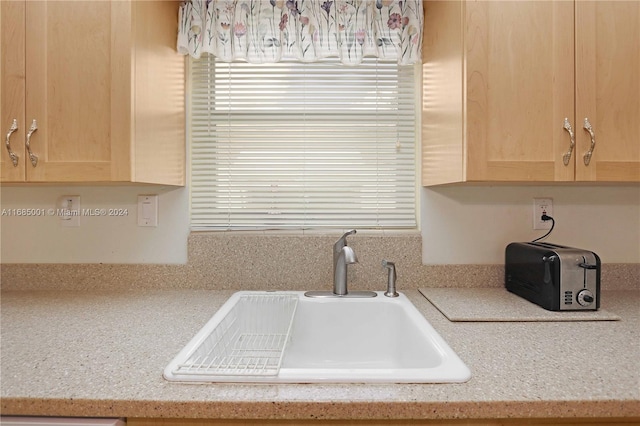 kitchen with sink and light brown cabinetry