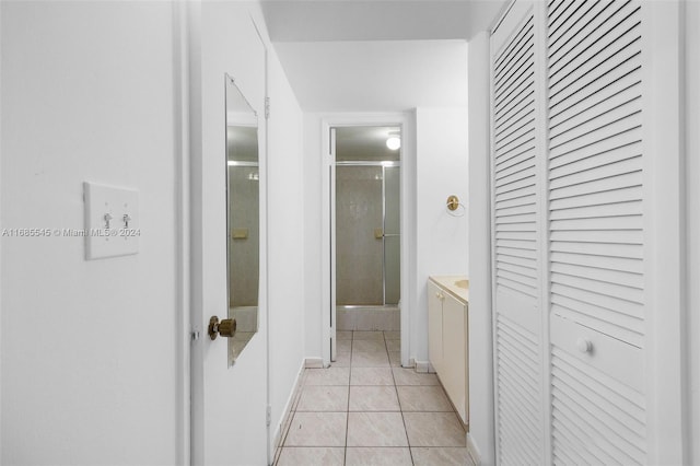 hall featuring light tile patterned flooring