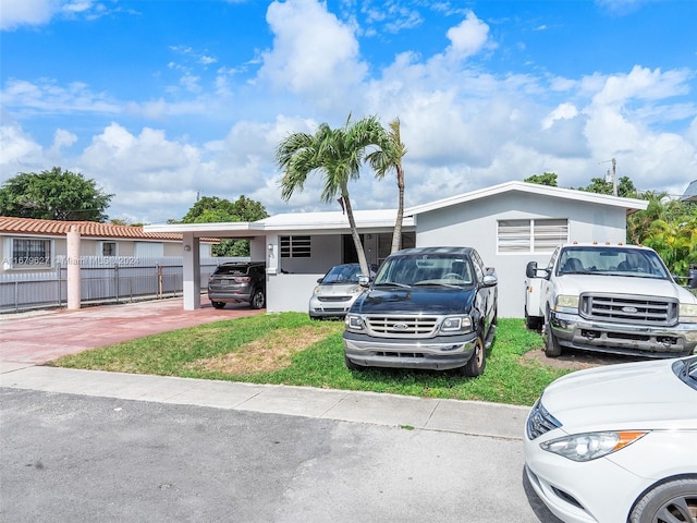 view of front facade with a front yard and a carport