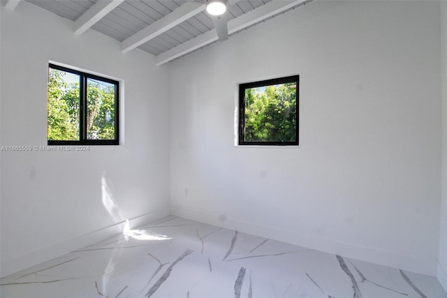 spare room featuring vaulted ceiling with beams and wood ceiling