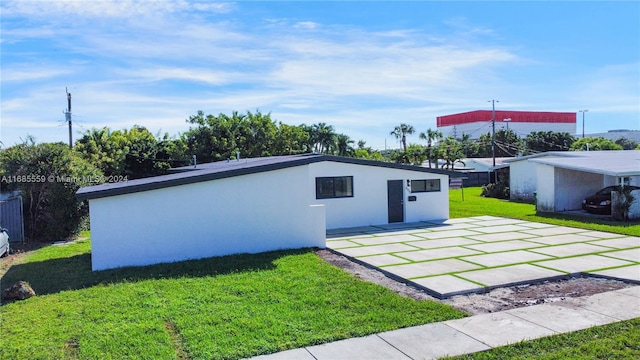 view of outbuilding featuring a lawn