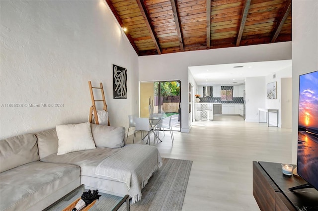 living room featuring beamed ceiling, high vaulted ceiling, wooden ceiling, and light wood-type flooring