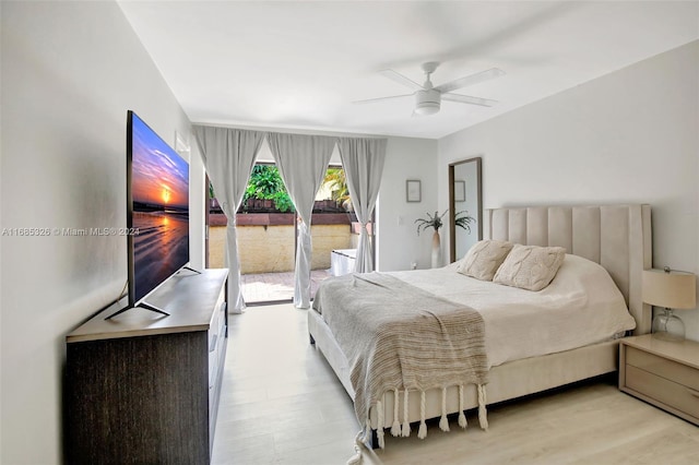 bedroom featuring access to exterior, light wood-type flooring, and ceiling fan