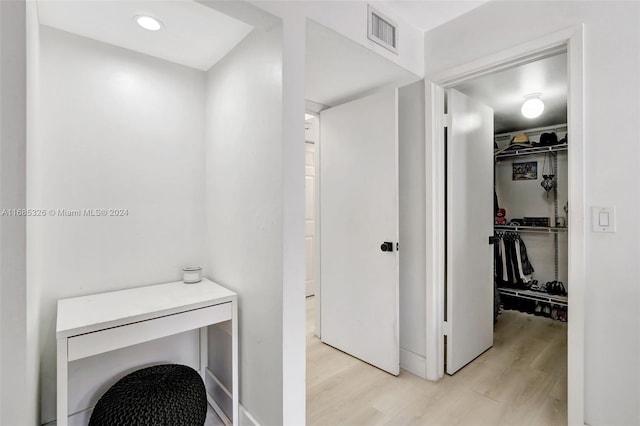 clothes washing area with light wood-type flooring