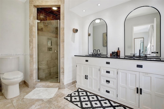 bathroom with vanity, a shower with shower door, and toilet