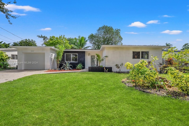 ranch-style home featuring a front lawn and a garage